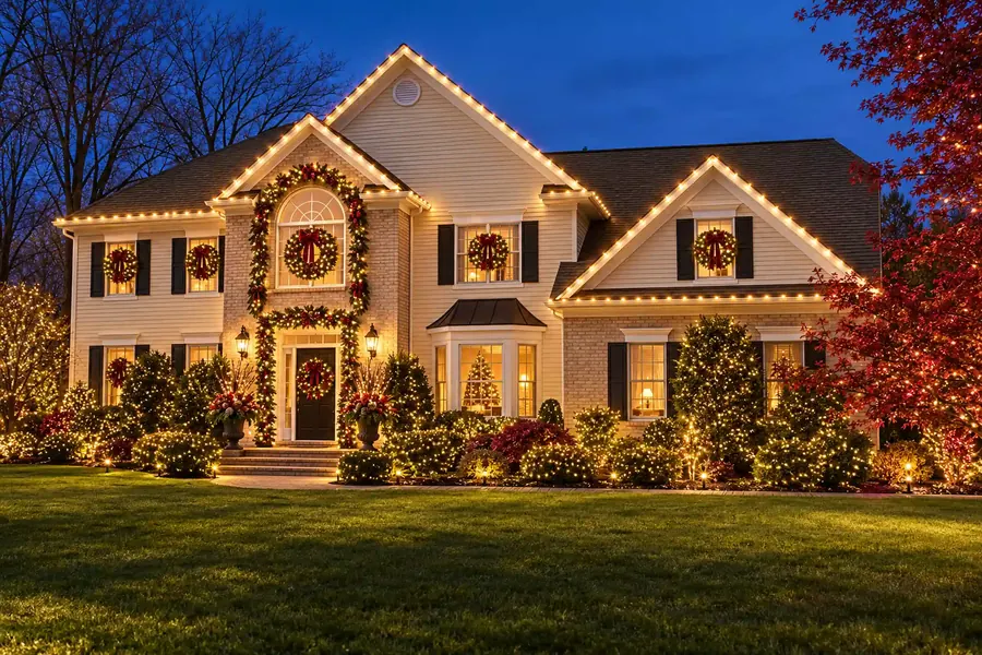 Grand Entrance package example: full facade with window wreaths, entry garland and lighting